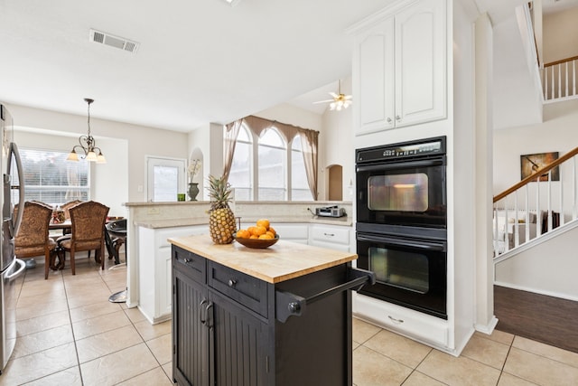 8501 Viridian Ln, Fort Worth, TX 76123 - kitchen featuring wooden counters, white cabinets, light tile patterned flooring, a peninsula, and pendant lighting