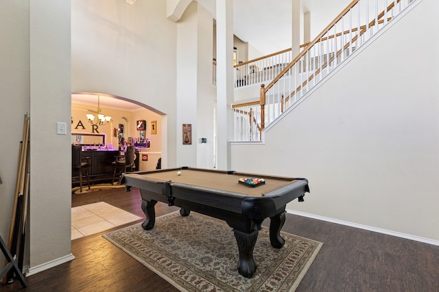 8501 Viridian Ln, Fort Worth, TX 76123 - playroom featuring wood finished floors, bar, a towering ceiling, billiards table, and arched walkways