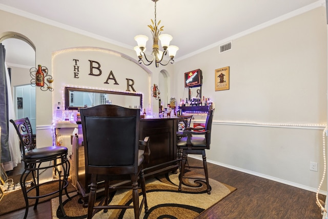 8501 Viridian Ln, Fort Worth, TX 76123 - dining room featuring a bar, ornamental molding, wood finished floors, and a chandelier
