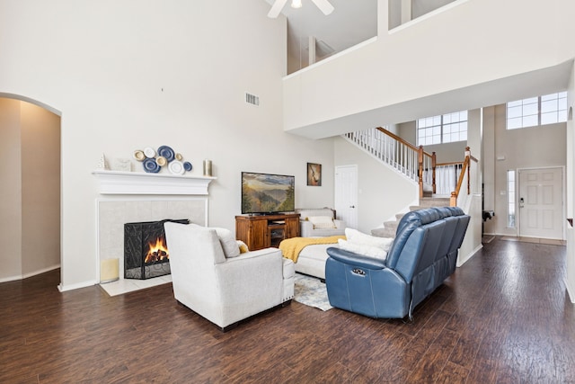 8501 Viridian Ln, Fort Worth, TX 76123 - living room with a high ceiling, wood finished floors, a fireplace, stairway, and arched walkways
