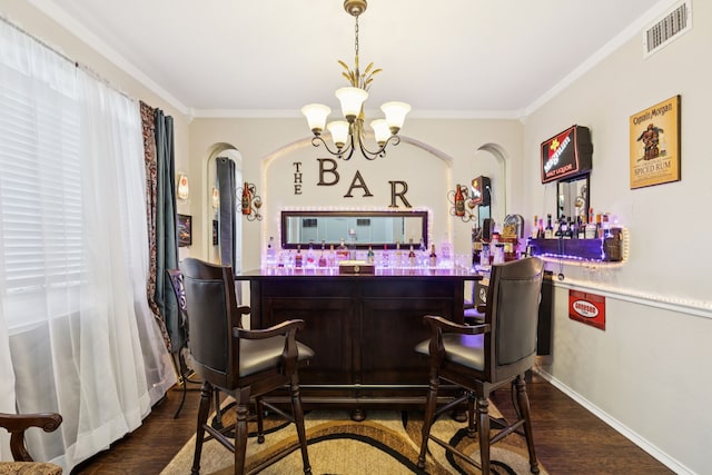 8501 Viridian Ln, Fort Worth, TX 76123 - indoor dry bar with ornamental molding, dark wood-style flooring, a chandelier, and arched walkways