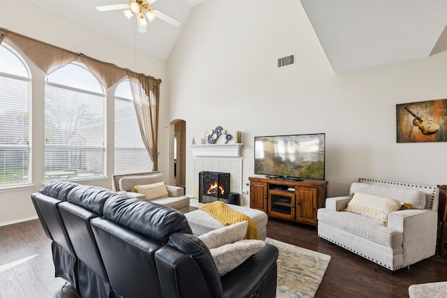8501 Viridian Ln, Fort Worth, TX 76123 - living area with ceiling fan, arched walkways, a fireplace, high vaulted ceiling, and dark wood-type flooring