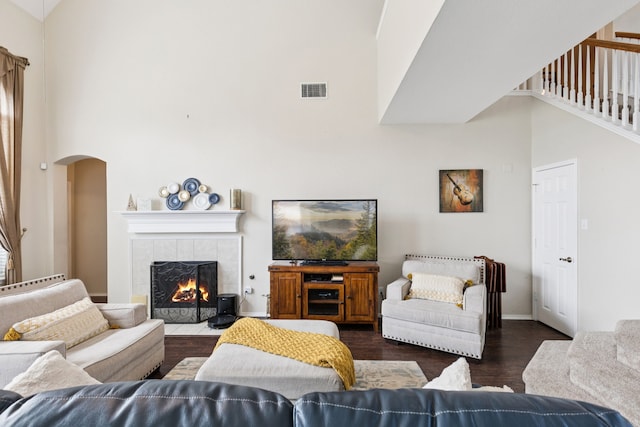 8501 Viridian Ln, Fort Worth, TX 76123 - living room with a high ceiling, wood finished floors, arched walkways, and a fireplace