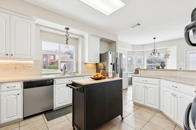 8501 Viridian Ln, Fort Worth, TX 76123 - kitchen featuring appliances with stainless steel finishes, light countertops, and decorative light fixtures