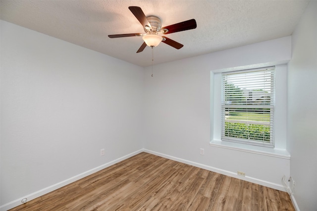 308 Crowe Dr, Euless, TX 76040 - empty room with light wood-style flooring, a textured ceiling, and a ceiling fan