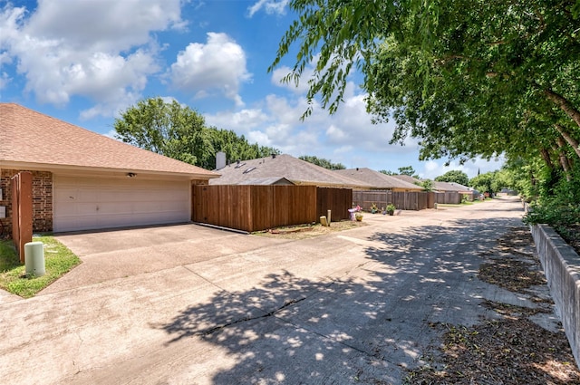 308 Crowe Dr, Euless, TX 76040 - view of side of home featuring concrete driveway, a garage, and brick siding