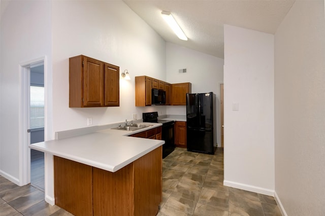 308 Crowe Dr, Euless, TX 76040 - kitchen featuring black appliances, high vaulted ceiling, a peninsula, light countertops, and brown cabinetry