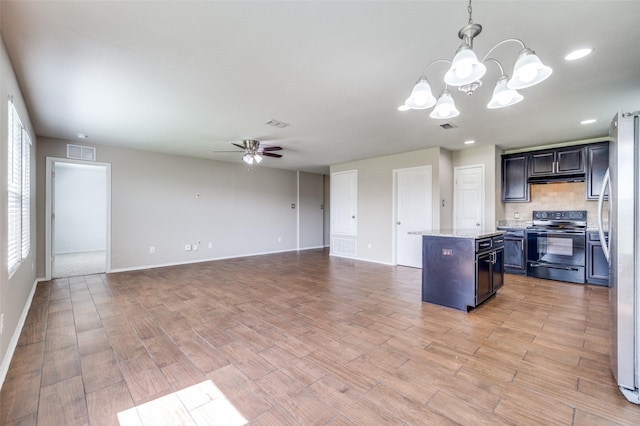 1221 Rivers Creek Ln, Little Elm, TX 75068 - kitchen featuring black / electric stove, freestanding refrigerator, a ceiling fan, a kitchen island, and light wood finished floors