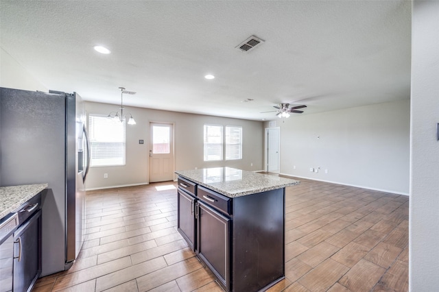 1221 Rivers Creek Ln, Little Elm, TX 75068 - kitchen with stainless steel fridge with ice dispenser, a ceiling fan, wood finish floors, a center island, and recessed lighting