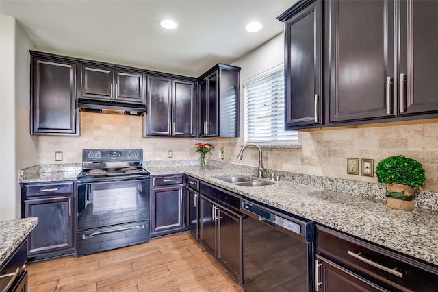 1221 Rivers Creek Ln, Little Elm, TX 75068 - kitchen with black appliances, under cabinet range hood, light stone countertops, decorative backsplash, and light wood-style floors