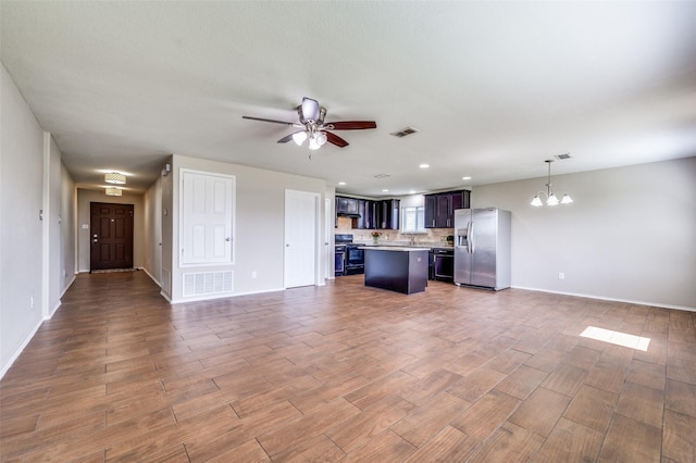 1221 Rivers Creek Ln, Little Elm, TX 75068 - unfurnished living room featuring a chandelier, a ceiling fan, wood finished floors, and recessed lighting