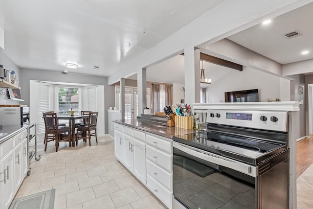 3905 Chestnut St, Fort Worth, TX 76137 - kitchen with stainless steel range with electric cooktop, white cabinets, light tile patterned floors, recessed lighting, and open shelves