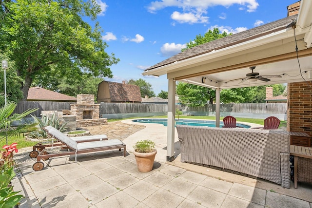 3905 Chestnut St, Fort Worth, TX 76137 - fenced backyard with an outdoor stone fireplace, a patio, and ceiling fan