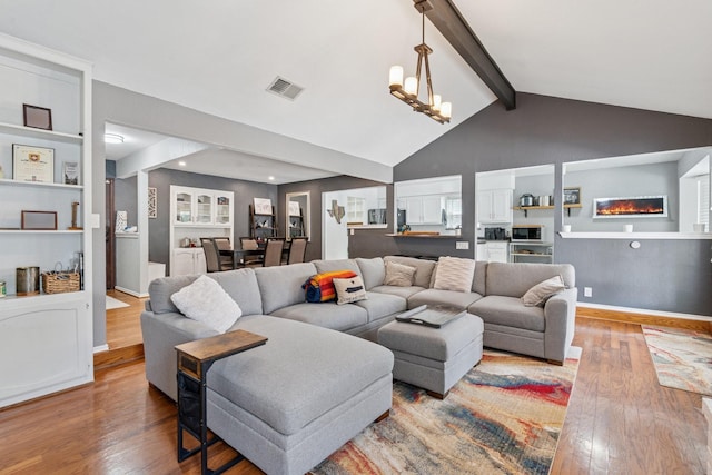 3905 Chestnut St, Fort Worth, TX 76137 - living room with hardwood / wood-style floors, beamed ceiling, a chandelier, high vaulted ceiling, and a fireplace