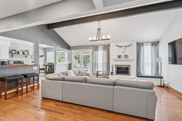 3905 Chestnut St, Fort Worth, TX 76137 - living area with wood finished floors, a chandelier, and a fireplace