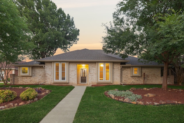 10306 Cimmaron Trl, Dallas, TX 75243 - view of front of property featuring a lawn, brick siding, and a shingled roof