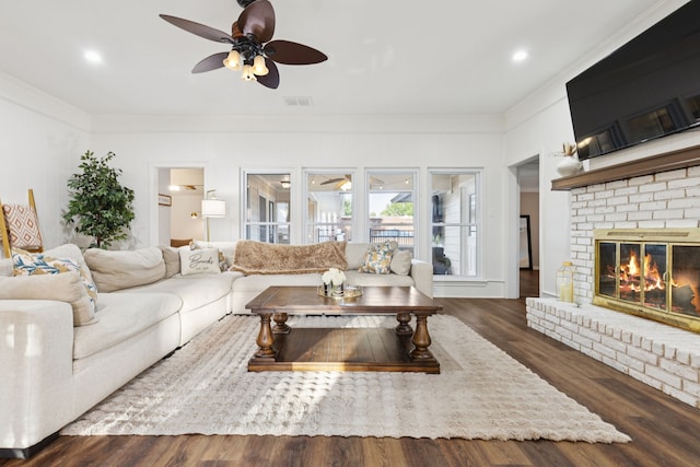 10306 Cimmaron Trl, Dallas, TX 75243 - living room featuring a ceiling fan, crown molding, a fireplace, wood finished floors, and recessed lighting