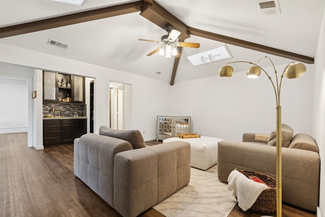 10306 Cimmaron Trl, Dallas, TX 75243 - living area featuring dark wood-style floors, ceiling fan, bar, and a skylight