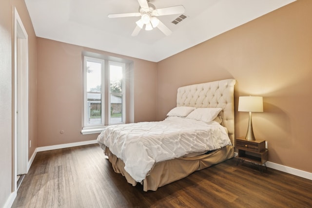 10306 Cimmaron Trl, Dallas, TX 75243 - bedroom with wood finished floors, a tray ceiling, and a ceiling fan