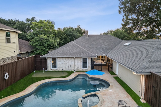 10306 Cimmaron Trl, Dallas, TX 75243 - view of swimming pool with a putting green, a fenced backyard, a patio area, and a pool with connected hot tub