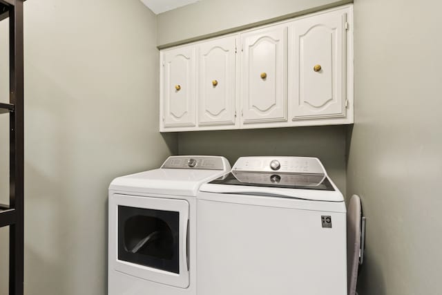 10306 Cimmaron Trl, Dallas, TX 75243 - washroom featuring washing machine and clothes dryer and cabinet space