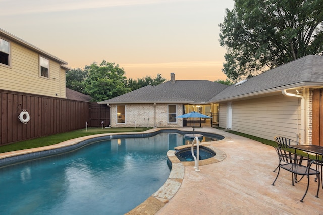 10306 Cimmaron Trl, Dallas, TX 75243 - view of swimming pool featuring a patio, a fenced backyard, and a pool with connected hot tub