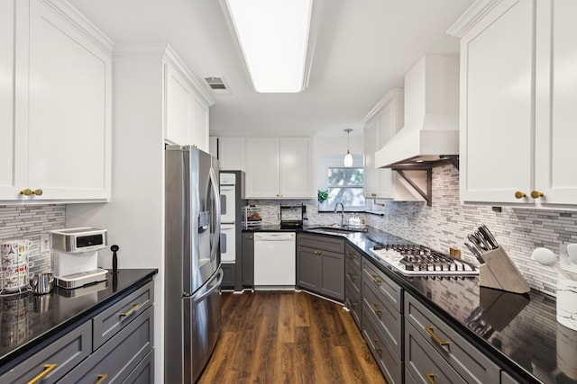 10306 Cimmaron Trl, Dallas, TX 75243 - kitchen featuring custom exhaust hood, appliances with stainless steel finishes, decorative backsplash, and dark wood finished floors