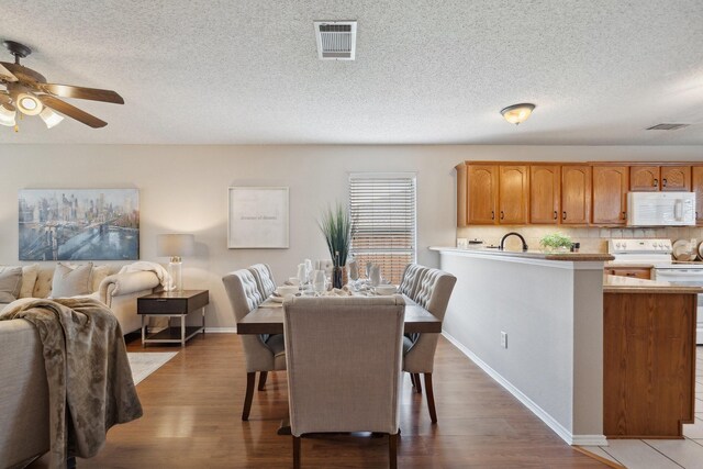 9129 Apollo Ct, Frisco, TX 75033 - dining space featuring a ceiling fan, wood finished floors, and a textured ceiling