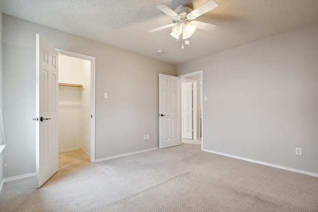 9129 Apollo Ct, Frisco, TX 75033 - unfurnished bedroom with light colored carpet, a walk in closet, a ceiling fan, and a closet