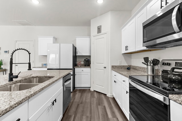 418 Madison Way, Princeton, TX 75407 - kitchen with appliances with stainless steel finishes, white cabinets, dark wood-style flooring, recessed lighting, and light stone countertops
