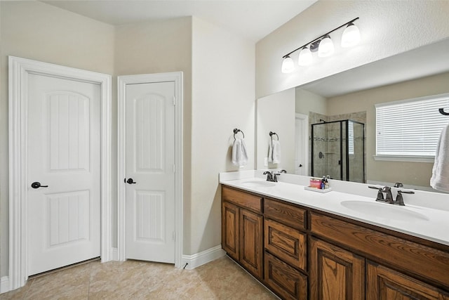 10704 Parnell Dr, Mckinney, TX 75072 - bathroom with a stall shower, double vanity, and tile patterned floors