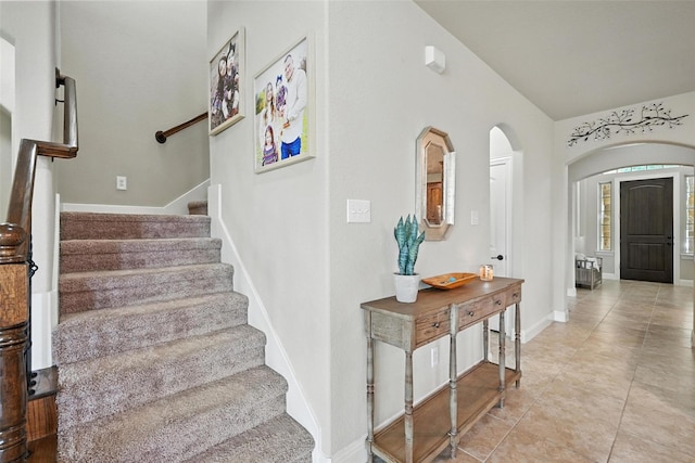10704 Parnell Dr, Mckinney, TX 75072 - stairway featuring arched walkways and tile patterned flooring