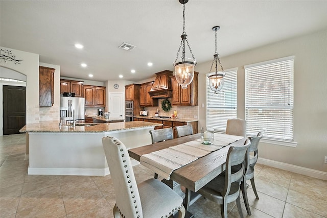 10704 Parnell Dr, Mckinney, TX 75072 - dining room with recessed lighting, light tile patterned floors, and a chandelier