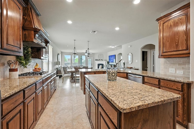 10704 Parnell Dr, Mckinney, TX 75072 - kitchen featuring open floor plan, appliances with stainless steel finishes, a fireplace, backsplash, and recessed lighting