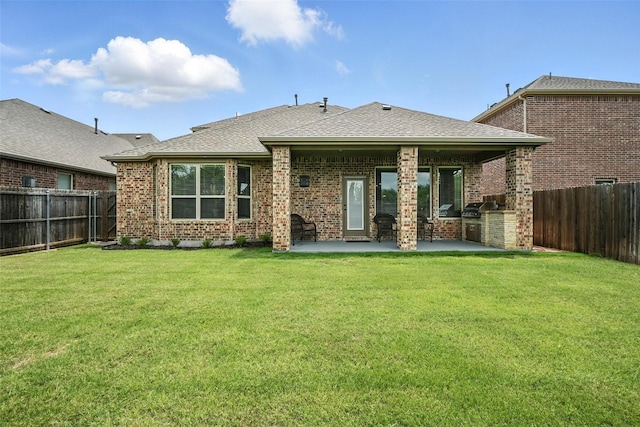 10704 Parnell Dr, Mckinney, TX 75072 - rear view of house featuring a fenced backyard, a patio area, brick siding, and roof with shingles