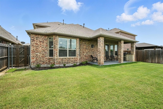 10704 Parnell Dr, Mckinney, TX 75072 - back of property with brick siding, a patio area, and a fenced backyard