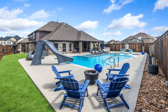 180 Highbridge Ln, Prosper, TX 75078 - view of pool featuring a water slide, a fenced backyard, a patio area, a residential view, and a pool with connected hot tub