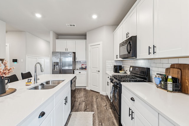 1560 Glacier Rdg, Royse City, TX 75189 - kitchen with black appliances, light countertops, dark wood finished floors, white cabinets, and recessed lighting
