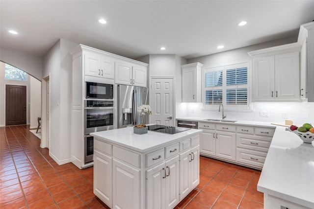 8931 Club Creek Cir, Dallas, TX 75238 - kitchen with black appliances, decorative backsplash, light tile patterned floors, recessed lighting, and white cabinetry