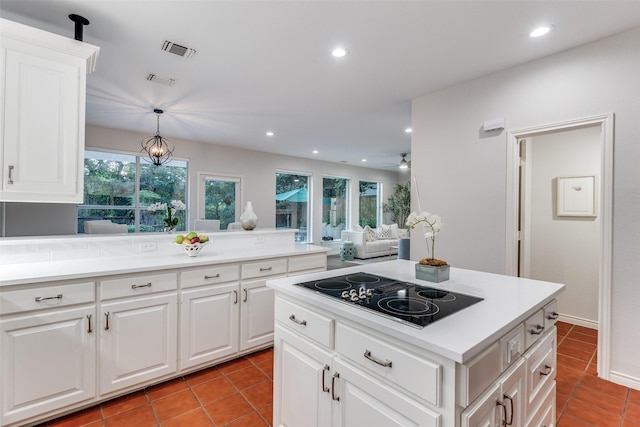 8931 Club Creek Cir, Dallas, TX 75238 - kitchen with black electric cooktop, light tile patterned floors, plenty of natural light, recessed lighting, and light countertops