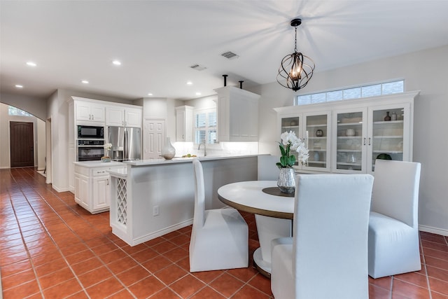 8931 Club Creek Cir, Dallas, TX 75238 - tiled dining room with arched walkways and recessed lighting