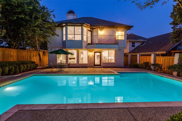 8931 Club Creek Cir, Dallas, TX 75238 - pool at night with a fenced backyard and a patio