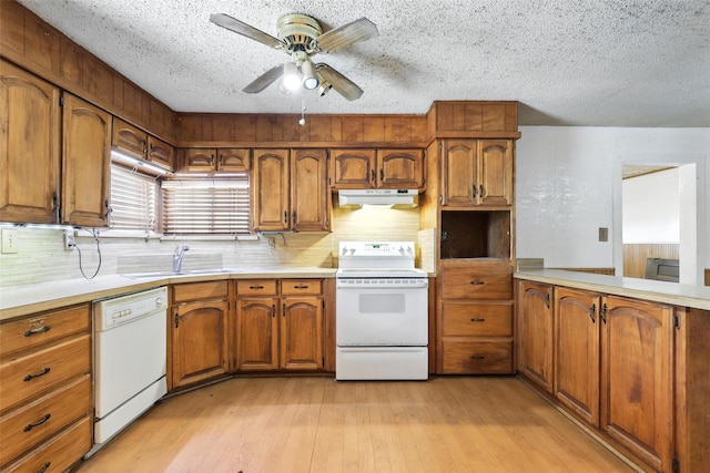 221 E 7th St, Weatherford, TX 76086 - kitchen with white appliances, under cabinet range hood, brown cabinets, a ceiling fan, and a textured ceiling