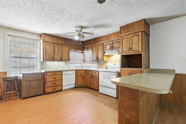 221 E 7th St, Weatherford, TX 76086 - kitchen with white appliances, light wood-style floors, ceiling fan, a peninsula, and under cabinet range hood