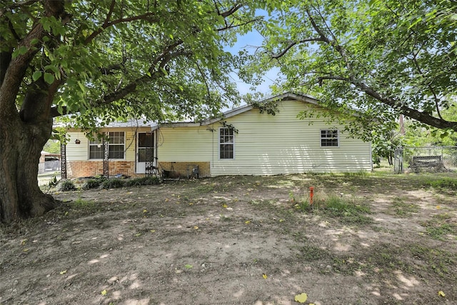 221 E 7th St, Weatherford, TX 76086 - rear view of property featuring brick siding