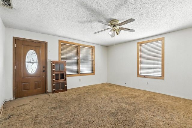 221 E 7th St, Weatherford, TX 76086 - carpeted foyer entrance with ceiling fan, a textured ceiling, and plenty of natural light