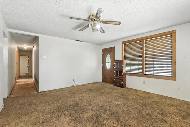 221 E 7th St, Weatherford, TX 76086 - foyer entrance with a textured ceiling, carpet floors, and ceiling fan