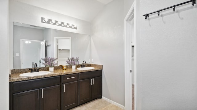 6348 Porthole Ln, Fort Worth, TX 76179 - bathroom featuring double vanity, a walk in closet, and tile patterned flooring
