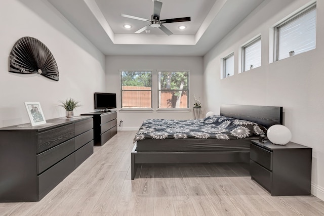 237 Gardenia Dr, Azle, TX 76020 - bedroom with light wood-style flooring, multiple windows, a tray ceiling, recessed lighting, and ceiling fan