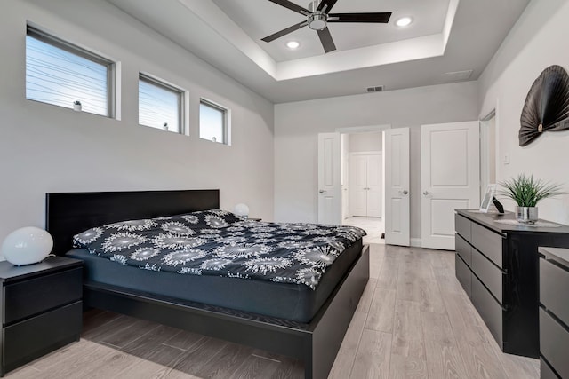 237 Gardenia Dr, Azle, TX 76020 - bedroom featuring a raised ceiling, light wood-style floors, ceiling fan, and recessed lighting